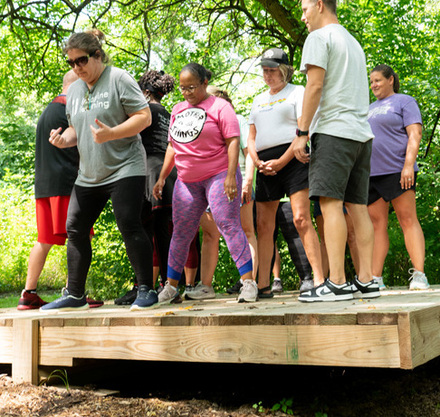 a group of people standing on a wooden platform