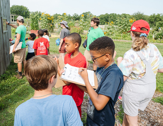 a group of children standing in a field