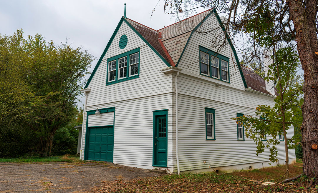 a white house with green doors