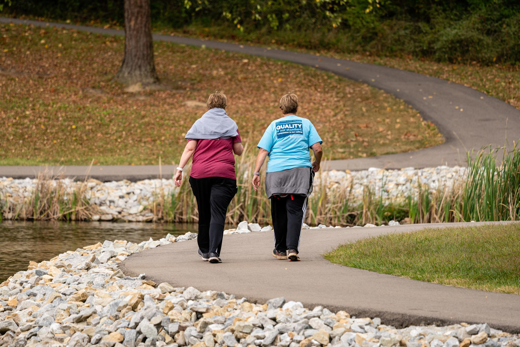 two women walking on a path