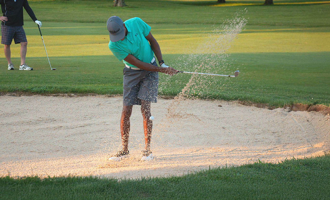a man swinging a golf club