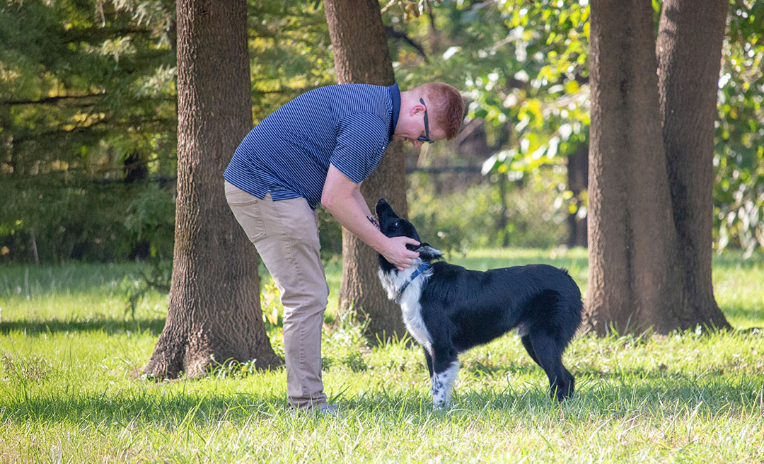 a man petting a dog