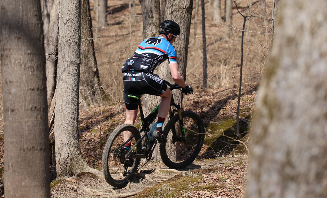 a man riding a bike in the woods
