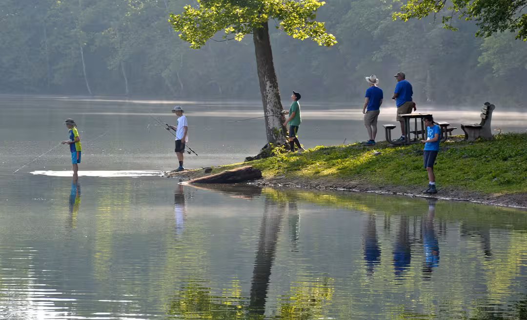 a group of people fishing on a lake