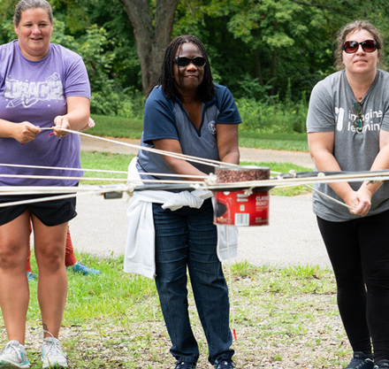 a group of women pulling a rope