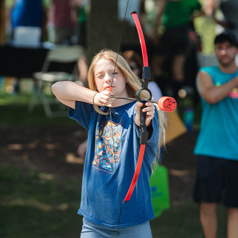 a girl shooting a bow and arrow