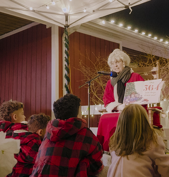 Mrs. Claus reading a story at Holidays on the Farm