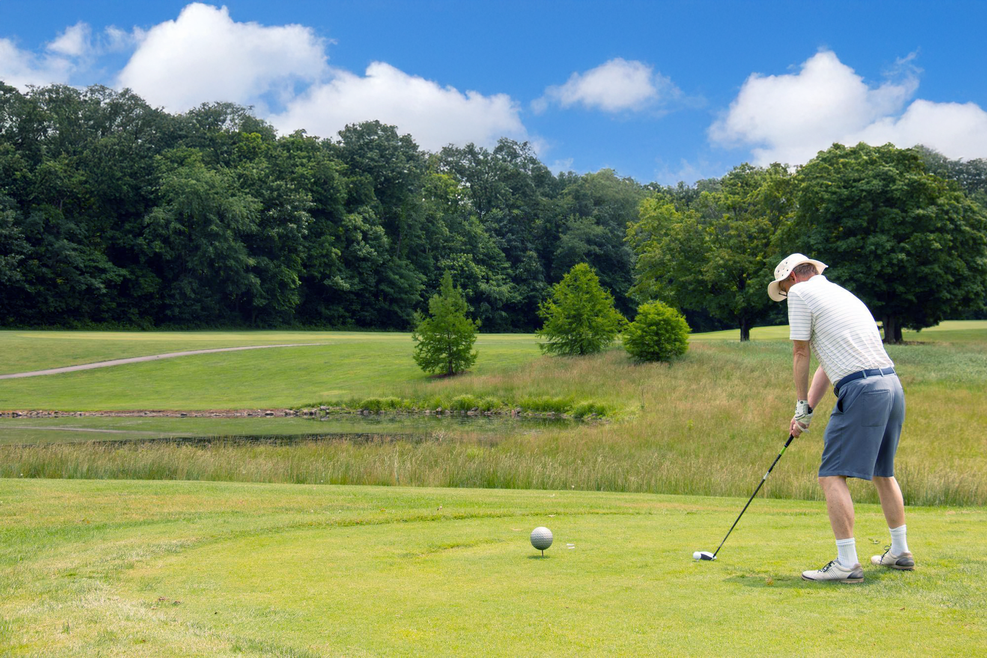 Golfer teeing off at Miami Whitewater Forest Golf Course
