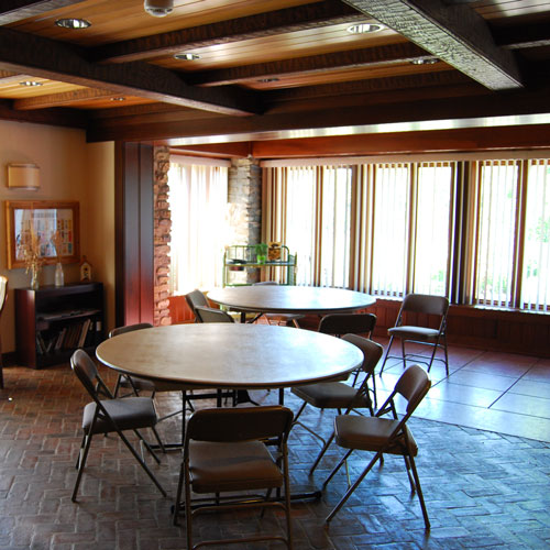 a room with a round table and chairs