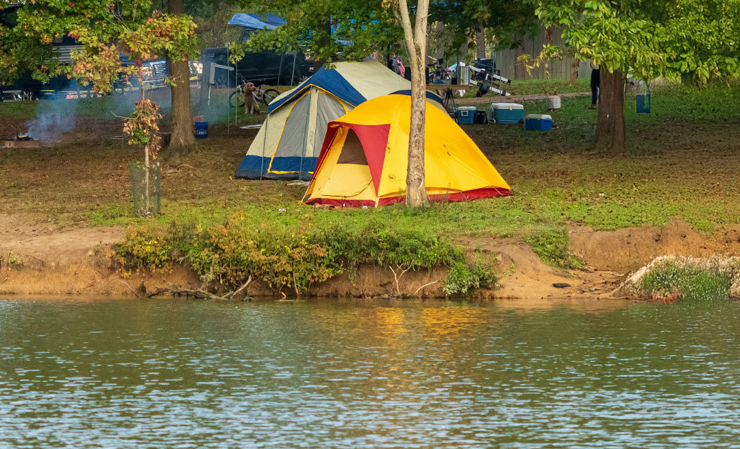 a group of tents next to a body of water