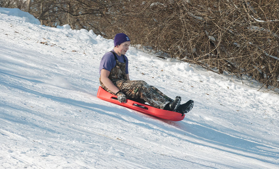 a man sledding down a hill