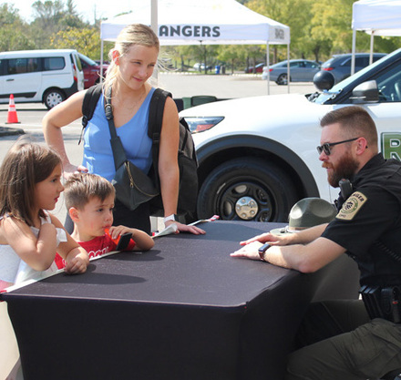 a police officer talking to a group of kids