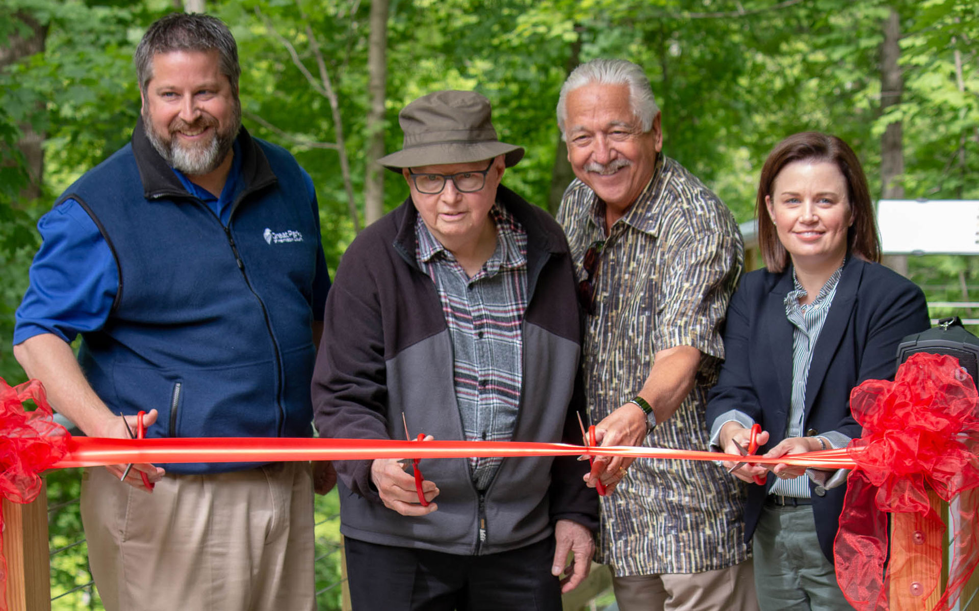 people cutting a red ribbon