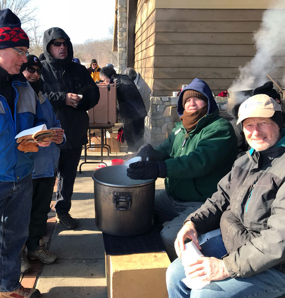 Hikers enjoying hot soup after a winter hike.