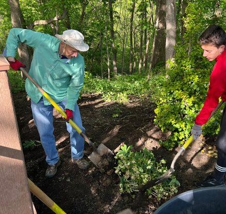 two men digging in the ground