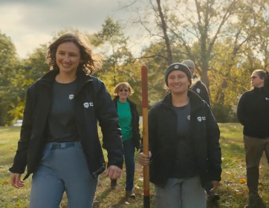 a group of people walking in a field