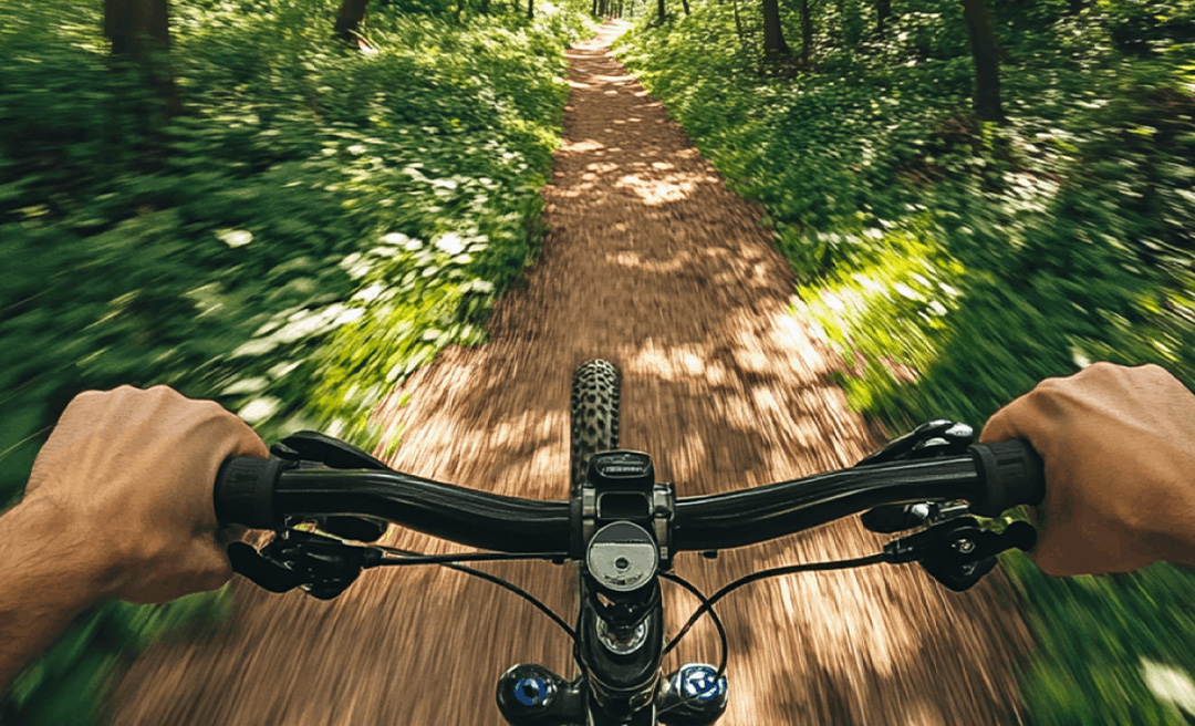a person riding a bike on a dirt road