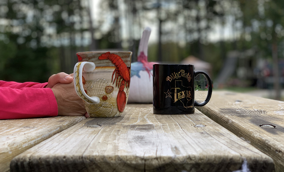 a hand holding a mug