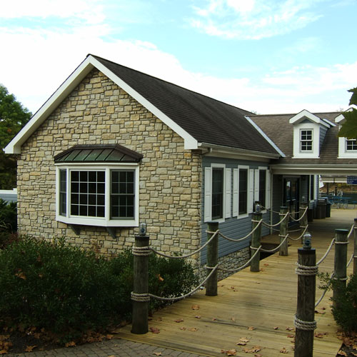a stone building with a walkway and rope