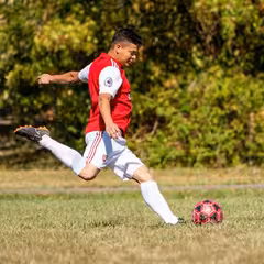 a man kicking a football ball