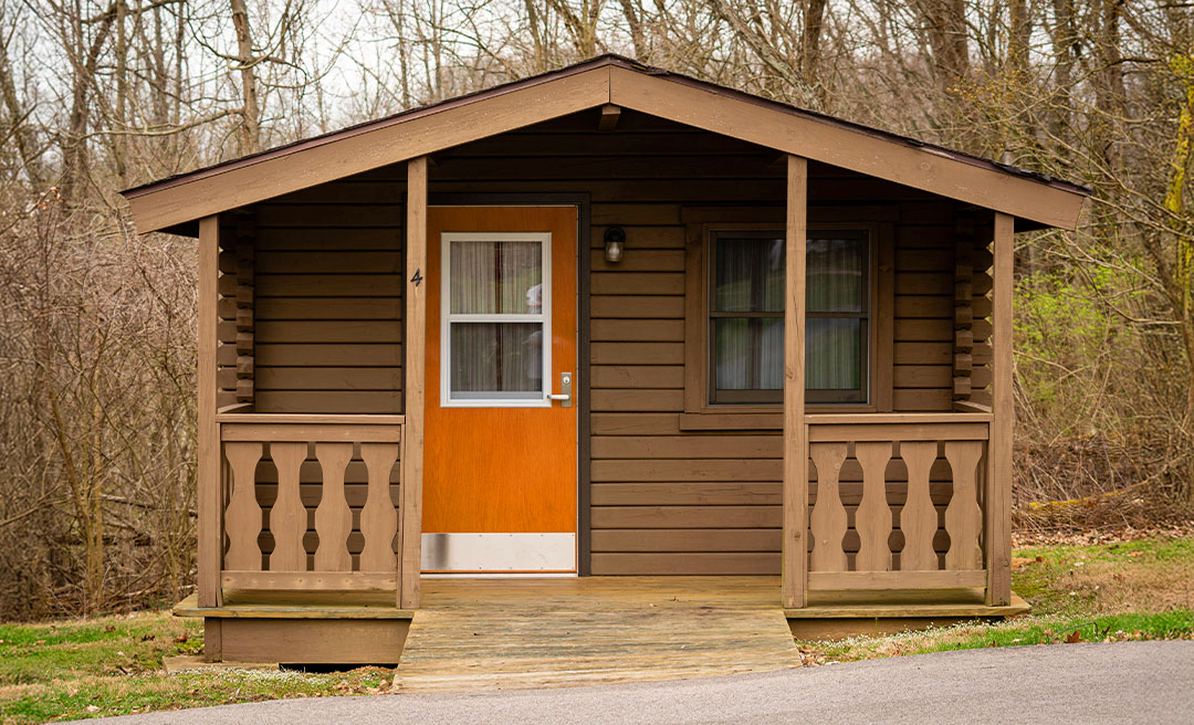 a small cabin with a porch and a door