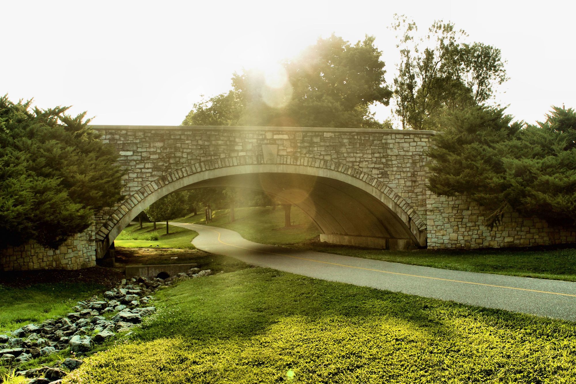 a stone bridge over a path