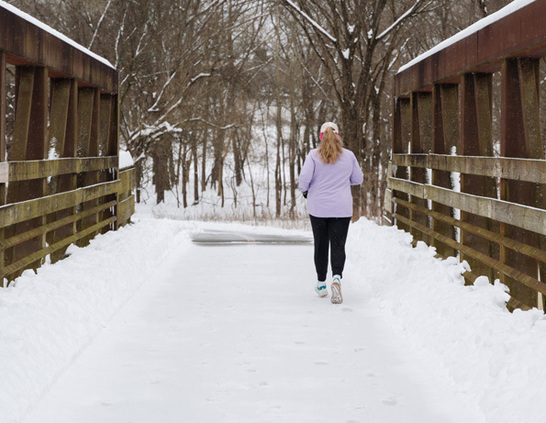 a woman walking on a snowy path
